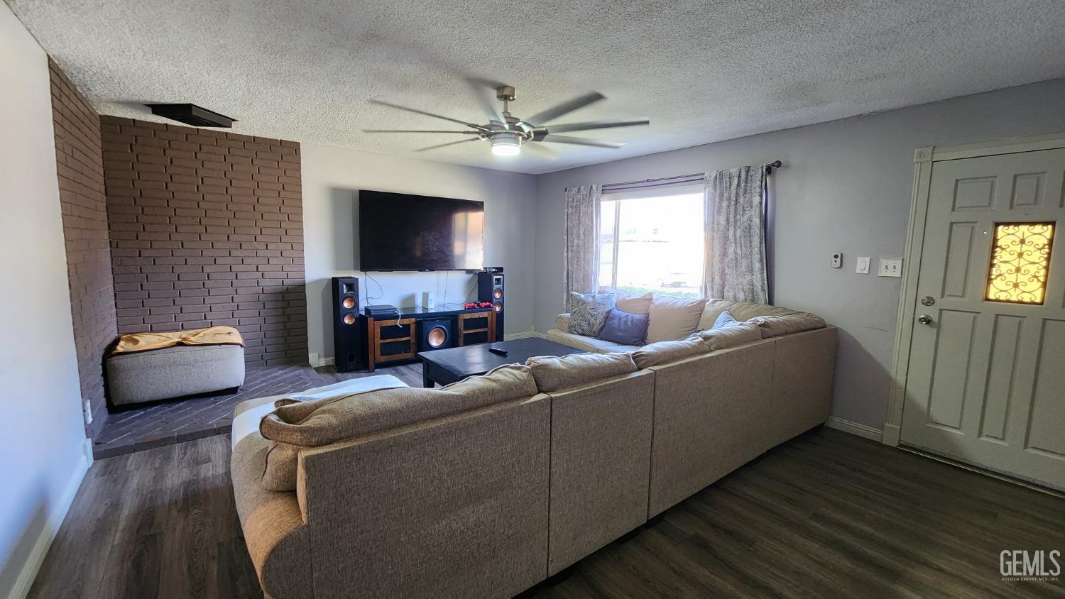 Undisclosed Address Bakersfield, CA 93306 - Photo 22 of 22 a living room with furniture and a flat screen tv