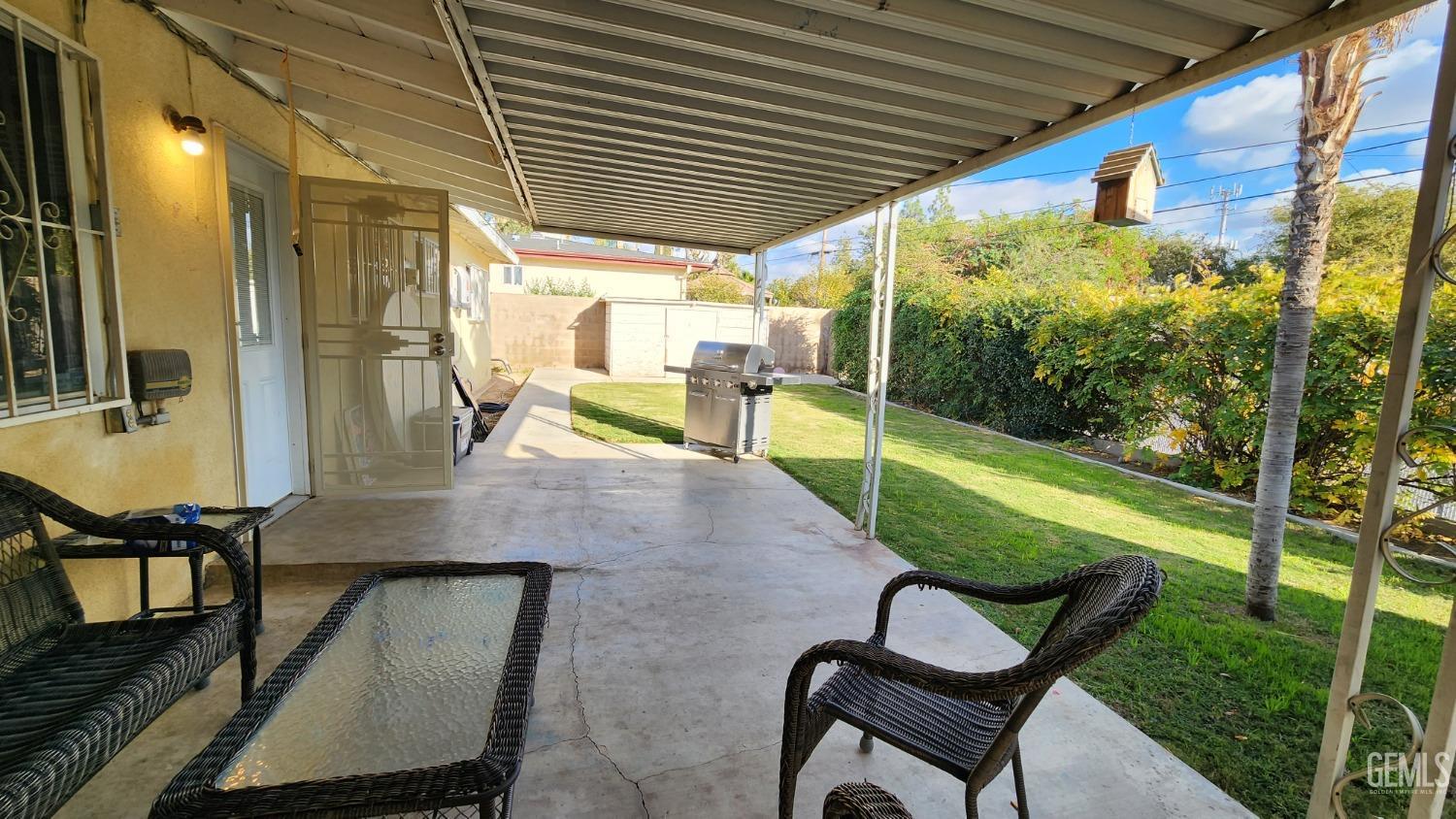 Undisclosed Address Bakersfield, CA 93306 - Photo 5 of 22 a view of a patio with table and chairs with wooden floor and fence