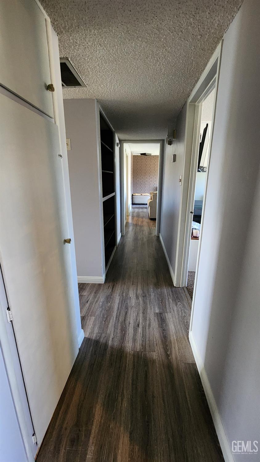 Undisclosed Address Bakersfield, CA 93306 - Photo 7 of 22 a view of a hallway view with wooden floor and staircase