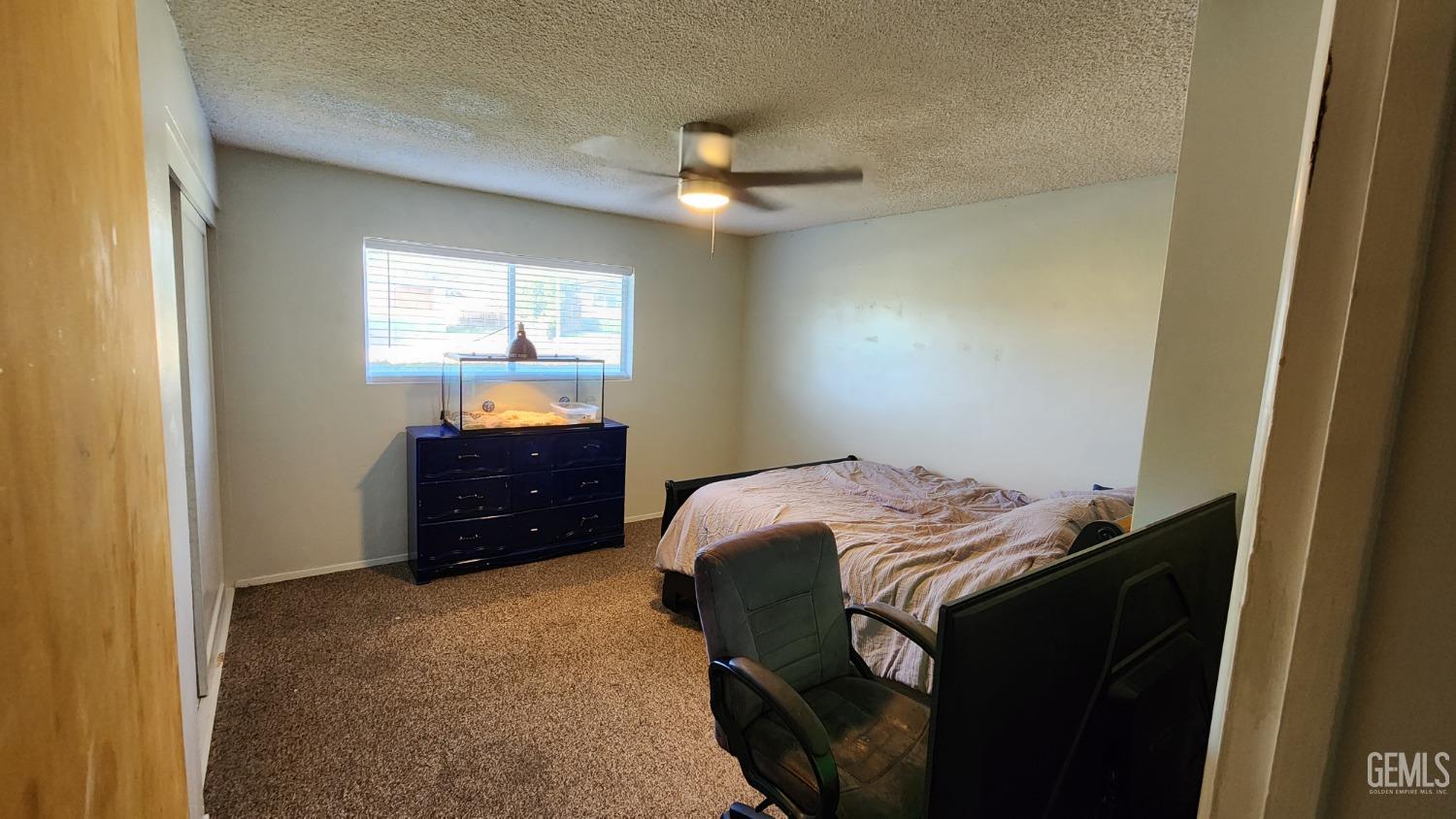 Undisclosed Address Bakersfield, CA 93306 - Photo 9 of 22 a bedroom with a bed and a window