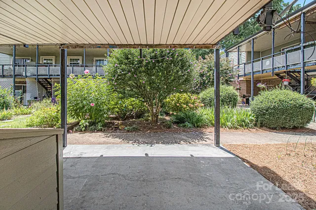 a backyard of a house with lots of green space and plants