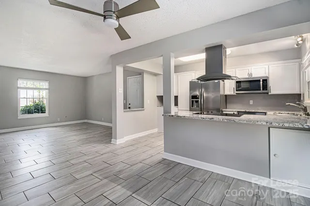 a view of a kitchen with a sink and a window