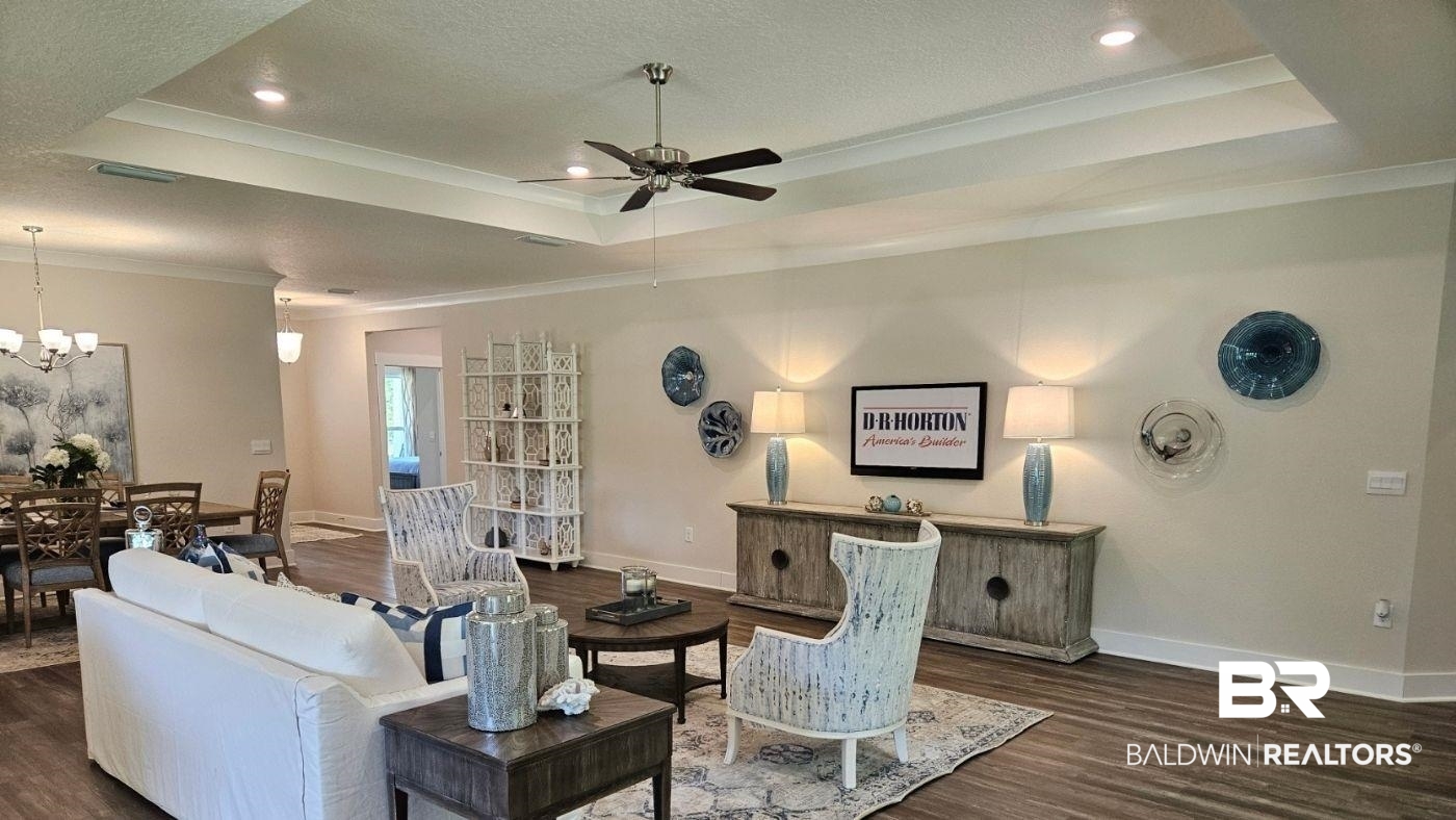 370 Barndling Street Fairhope, AL 36532 - Photo 27 of 30 Living room with ceiling fan with notable chandelier, a textured ceiling, a tray ceiling, and dark hardwood / wood-style floors