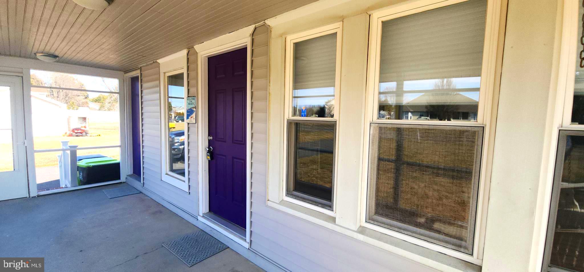 19773 Old Landing Road Rehoboth Beach, DE 19971 - Photo 13 of 54 a view of a hallway with wooden floor and a kitchen