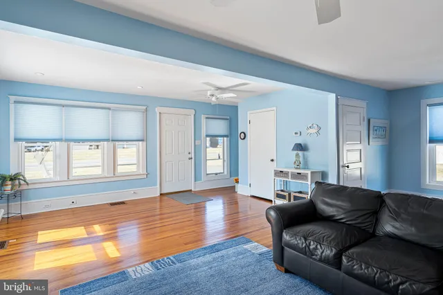 a kitchen with cabinets appliances and a wooden floor