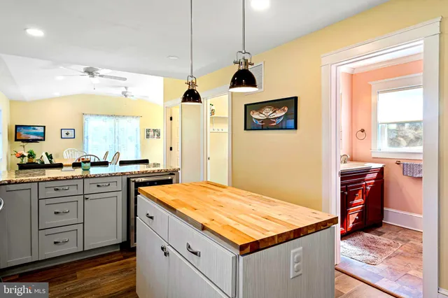 a kitchen with granite countertop kitchen island cabinets and refrigerator