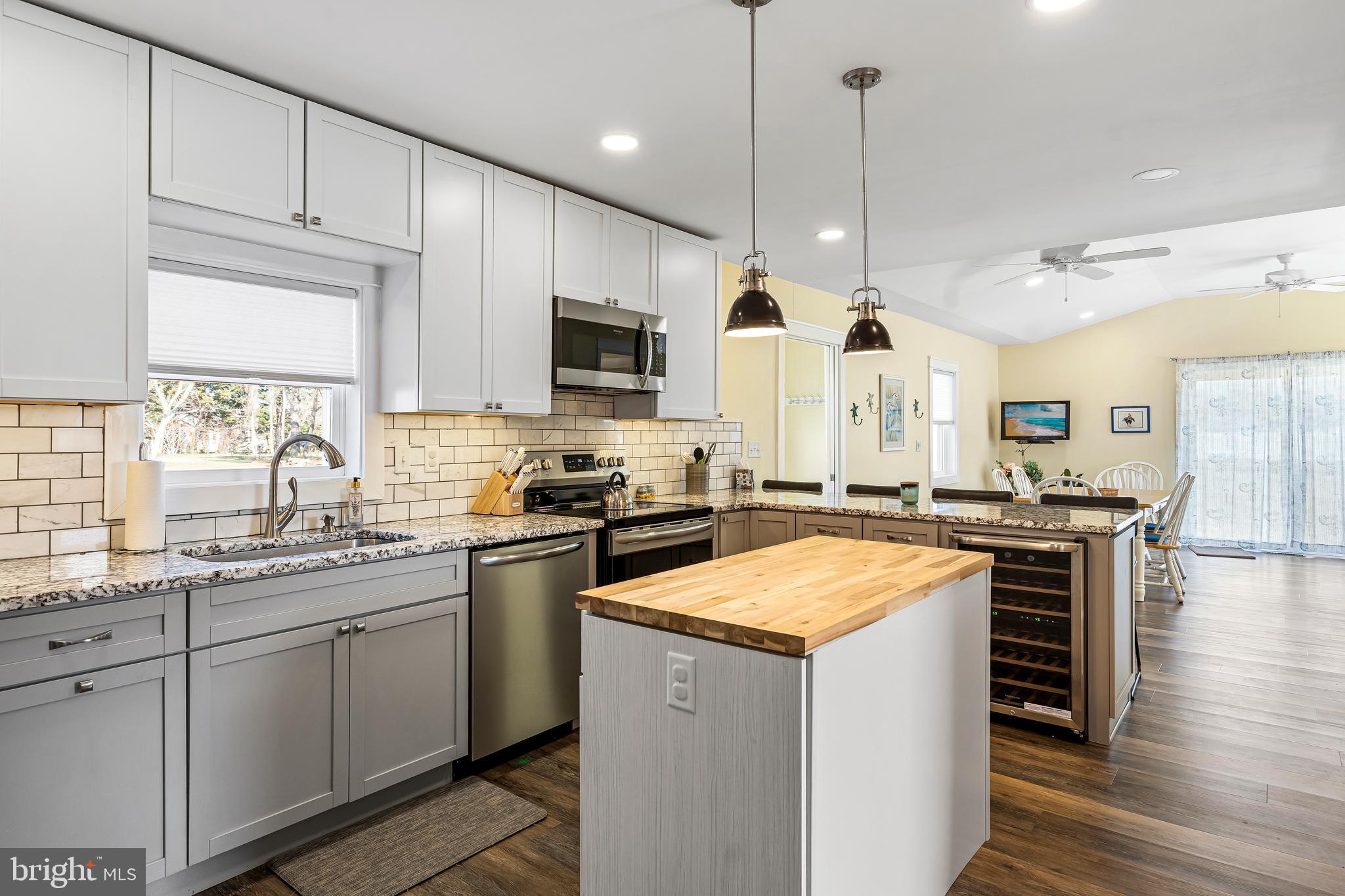 19773 Old Landing Road Rehoboth Beach, DE 19971 - Photo 27 of 54 a kitchen with cabinets appliances and a wooden floor