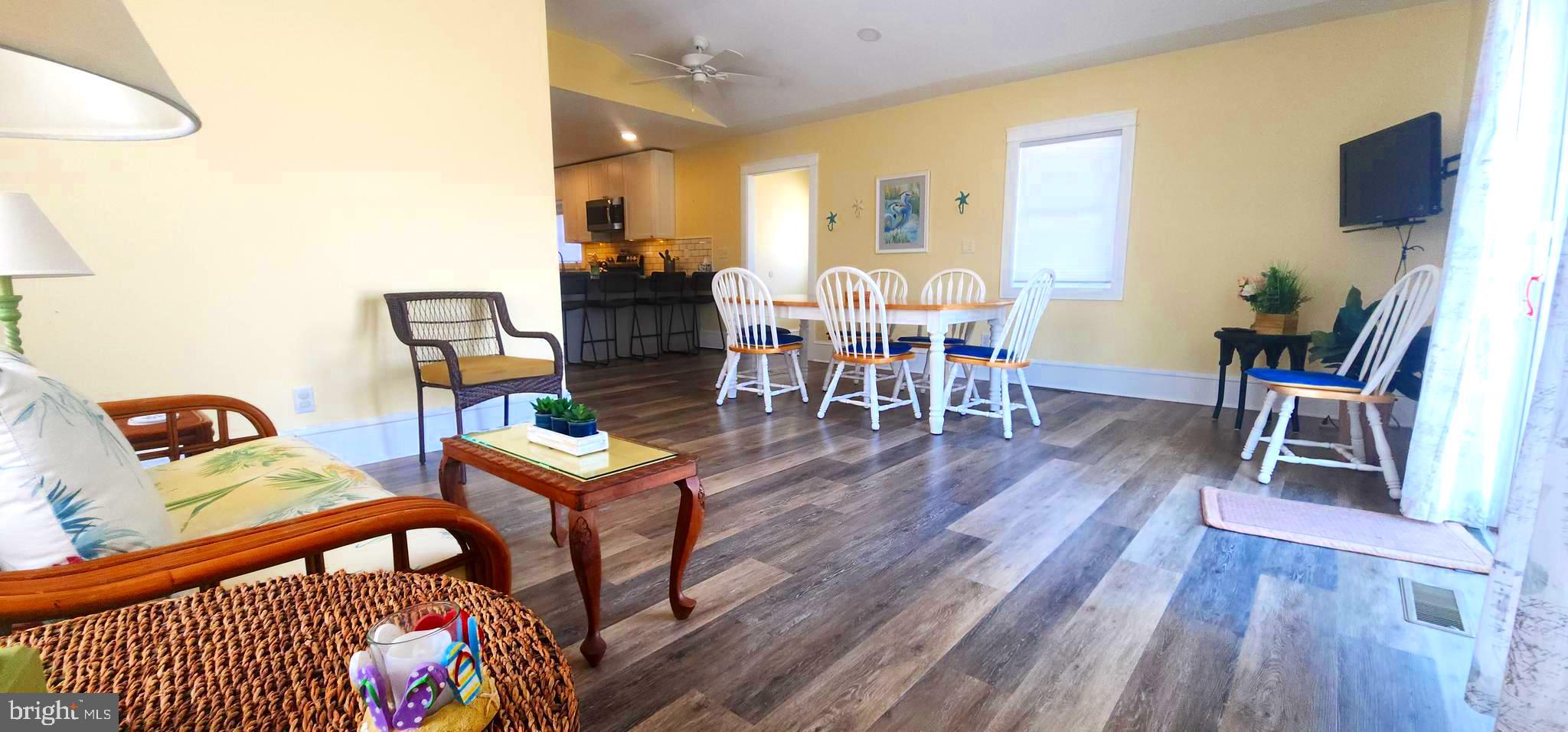 19773 Old Landing Road Rehoboth Beach, DE 19971 - Photo 30 of 54 a view of a dining room with furniture and wooden floor