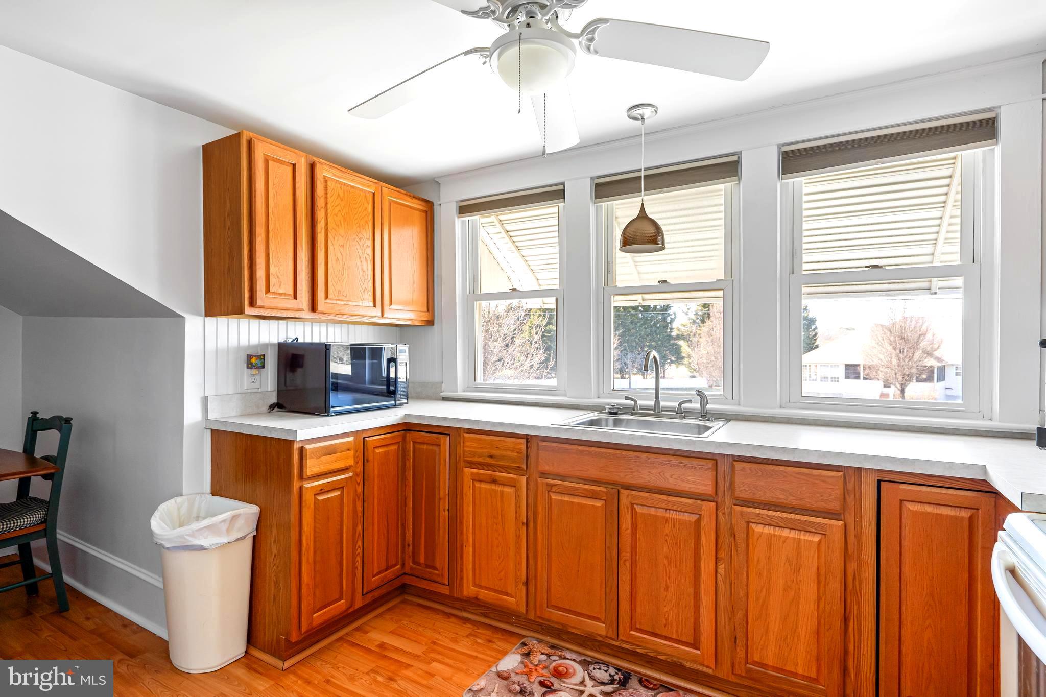 19773 Old Landing Road Rehoboth Beach, DE 19971 - Photo 38 of 54 a kitchen with sink a window and cabinets