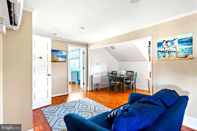 a view of livingroom with hardwood floor and a bathroom