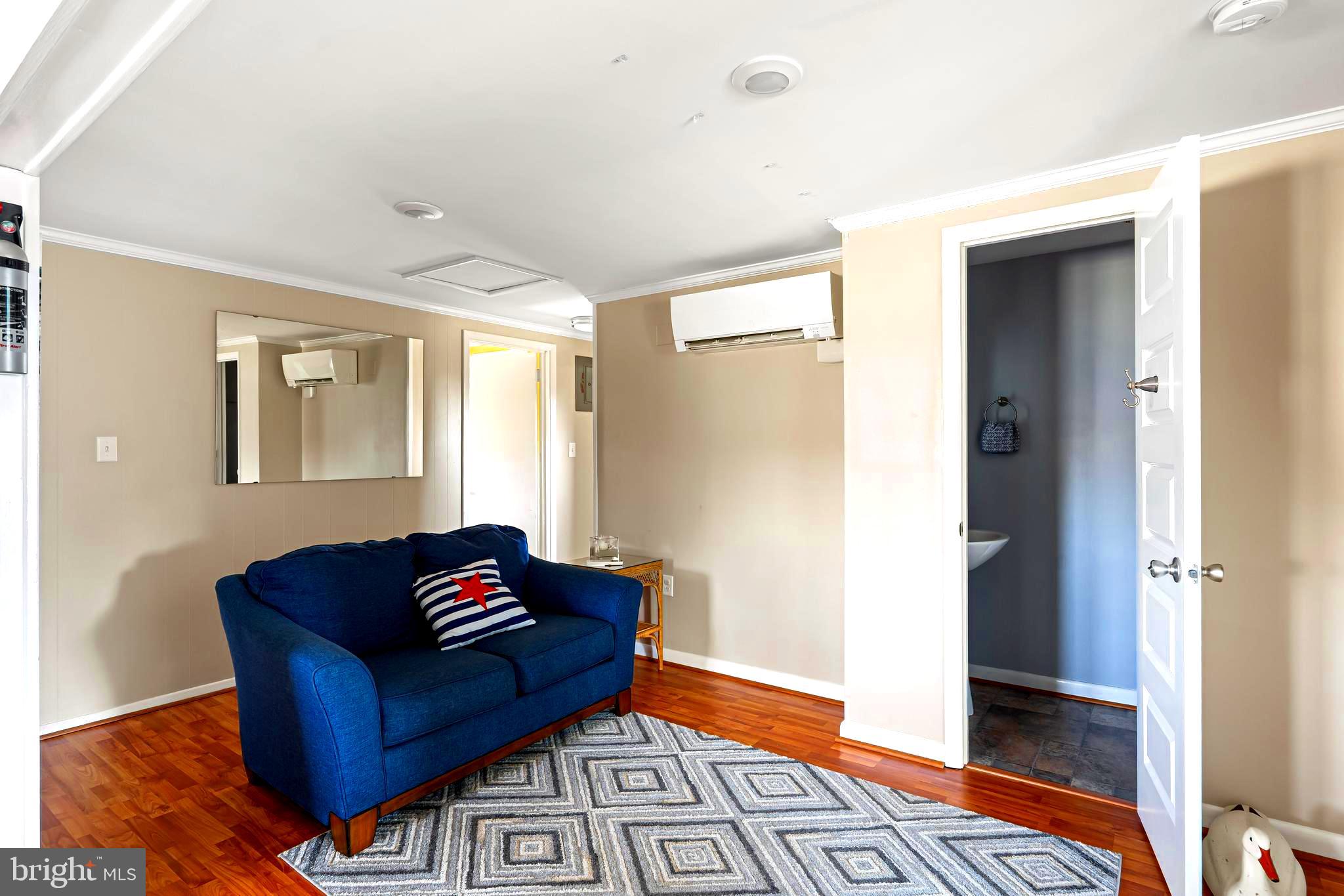 19773 Old Landing Road Rehoboth Beach, DE 19971 - Photo 42 of 54 a living room with furniture and a window