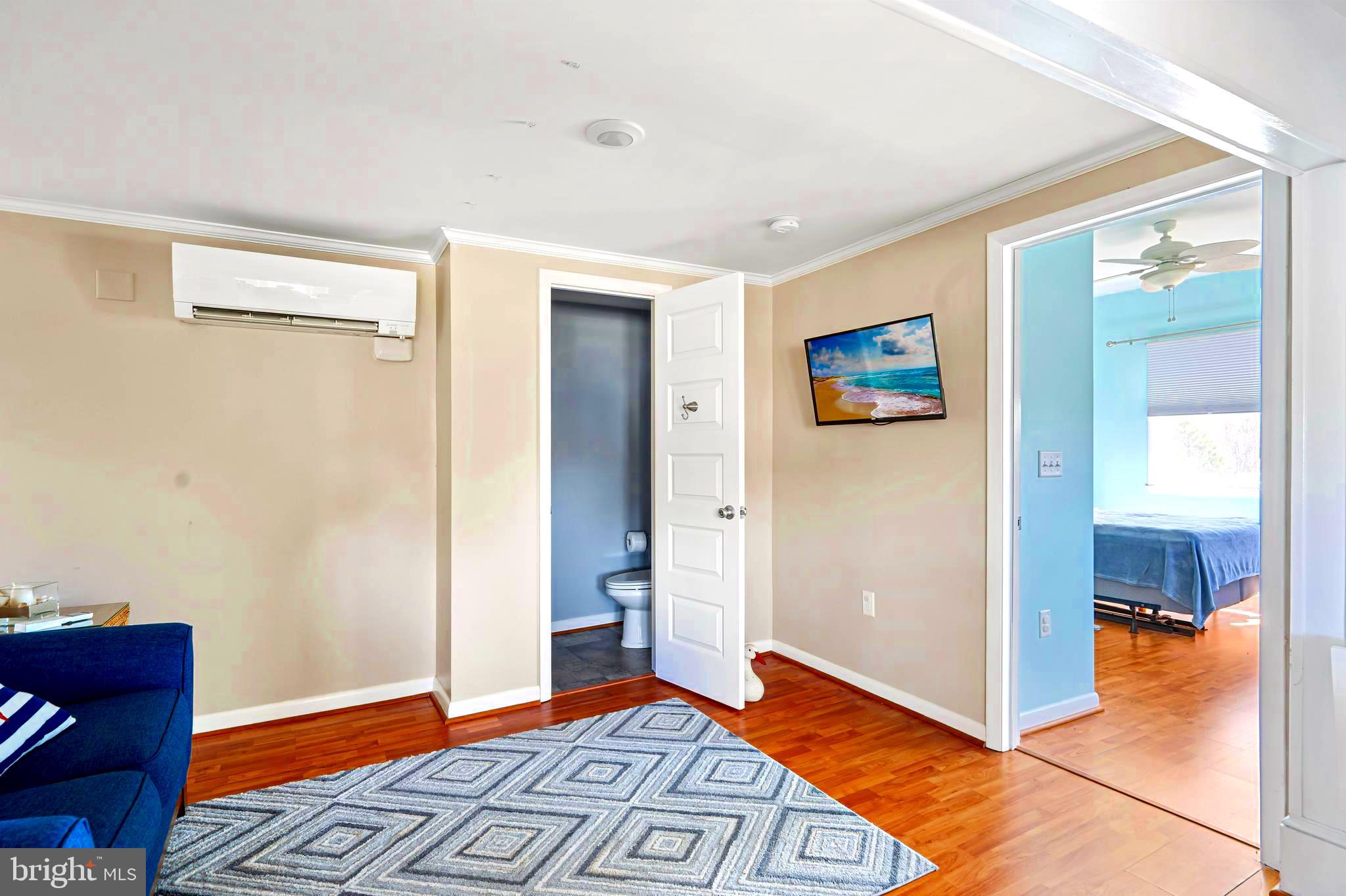 19773 Old Landing Road Rehoboth Beach, DE 19971 - Photo 43 of 54 a view of livingroom with hardwood floor and a bathroom