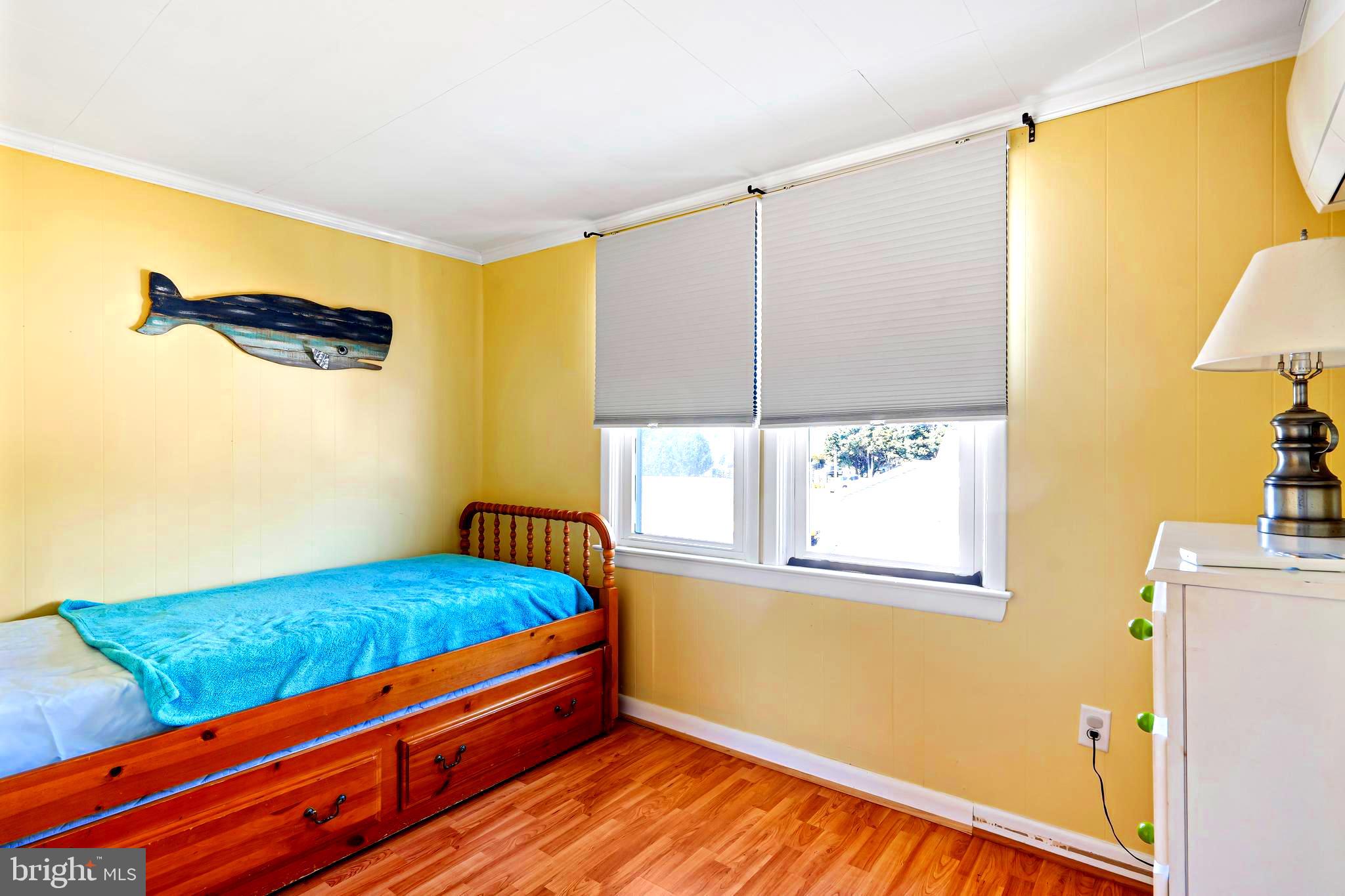 19773 Old Landing Road Rehoboth Beach, DE 19971 - Photo 46 of 54 a bedroom with a bed and a window