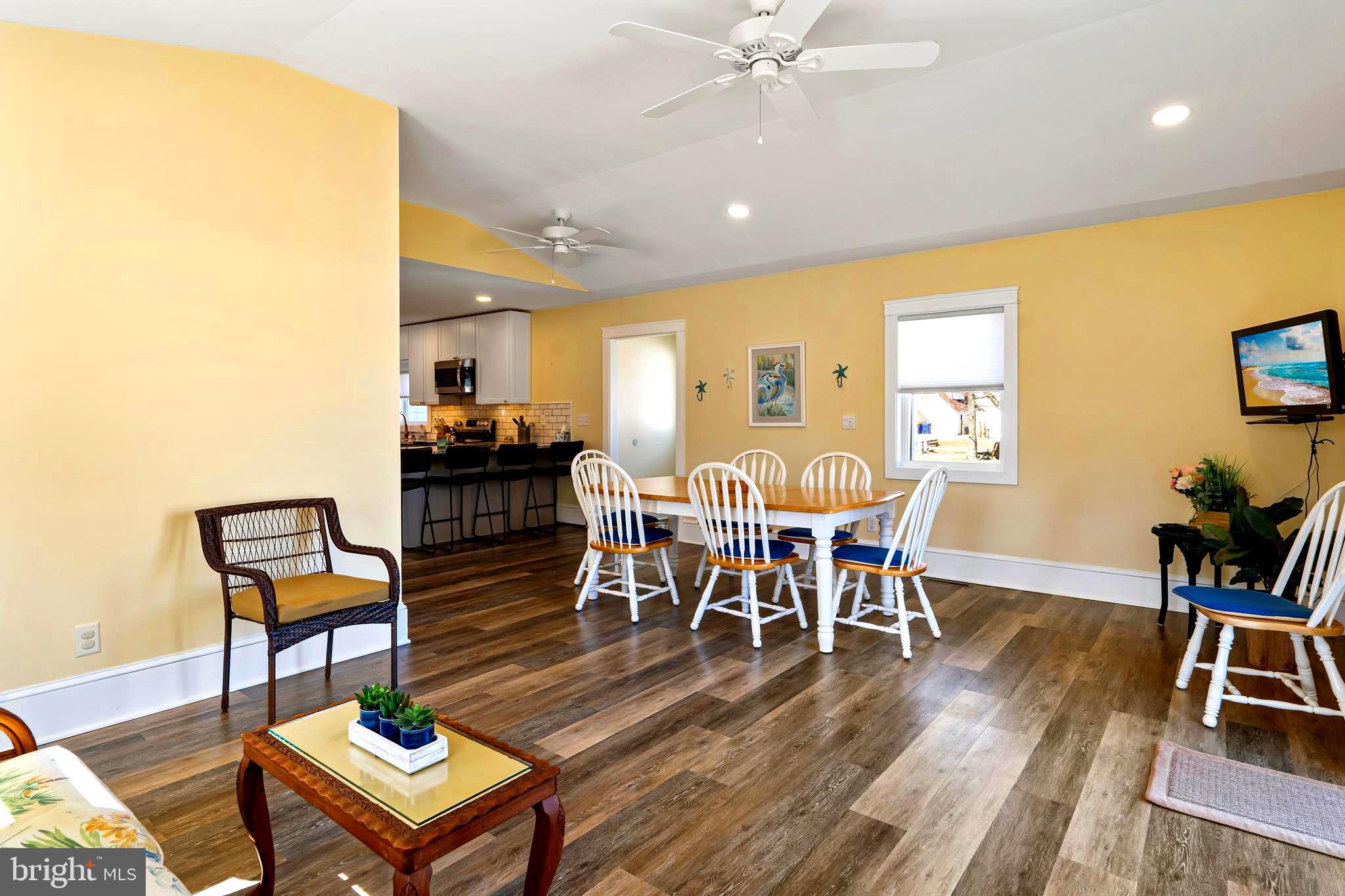 19773 Old Landing Road Rehoboth Beach, DE 19971 - Photo 5 of 54 a view of a dining room with furniture and wooden floor