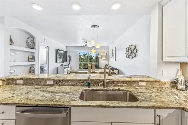 a bedroom with a bed and painting on the wall