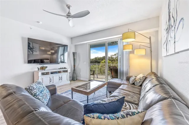 a bedroom with a bed and a flat tv screen on dresser