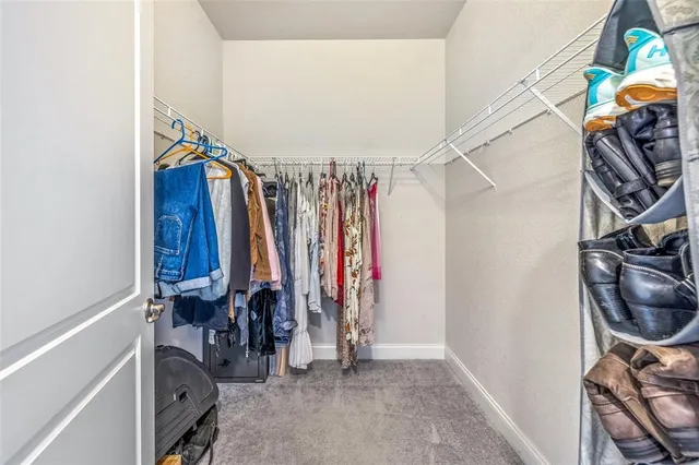 a bedroom with a bed a chandelier and a window