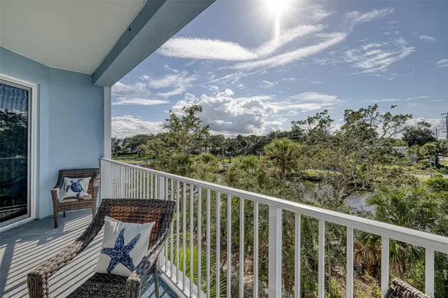 a living room with furniture large windows and wooden floor