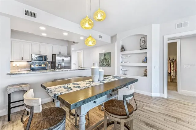 a dining room with furniture and wooden floor