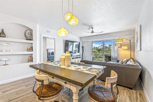 a kitchen with kitchen island granite countertop a sink cabinets and stainless steel appliances