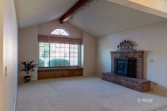 323 West Pilgrim Court Ridgecrest, CA 93555 - Photo 6 of 35 a living room with furniture and a fireplace