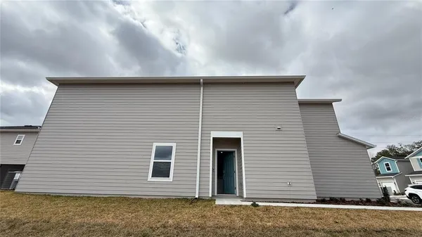 a view of a house with a yard and garage