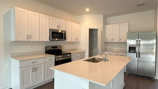 a kitchen with a sink a stove and refrigerator