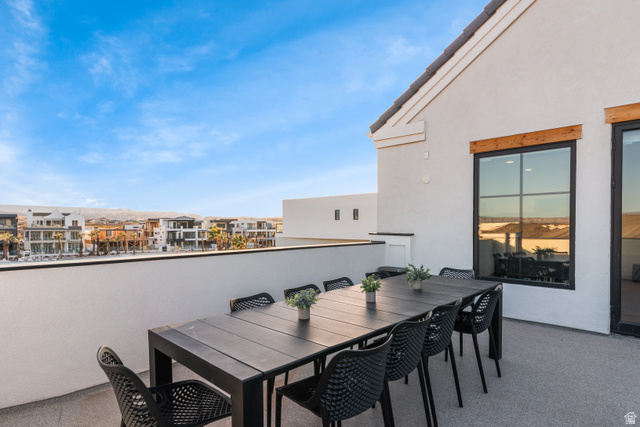 5367 Cyan Lane St. George, UT 84790 - Photo 36 of 49 Expansive rooftop deck featuring a stucco exterior, black-framed windows with wood accents, and a dark tile roof
