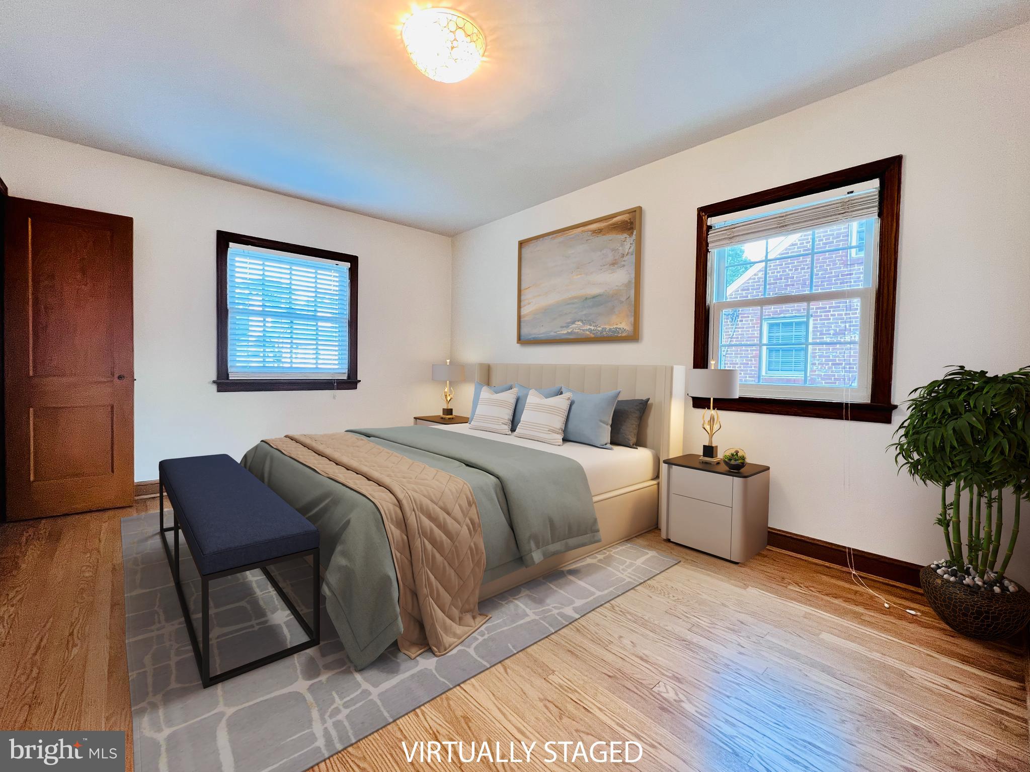 7208 Exeter Road Bethesda, MD 20814 - Photo 14 of 26 a spacious bedroom with a large bed and a potted plant