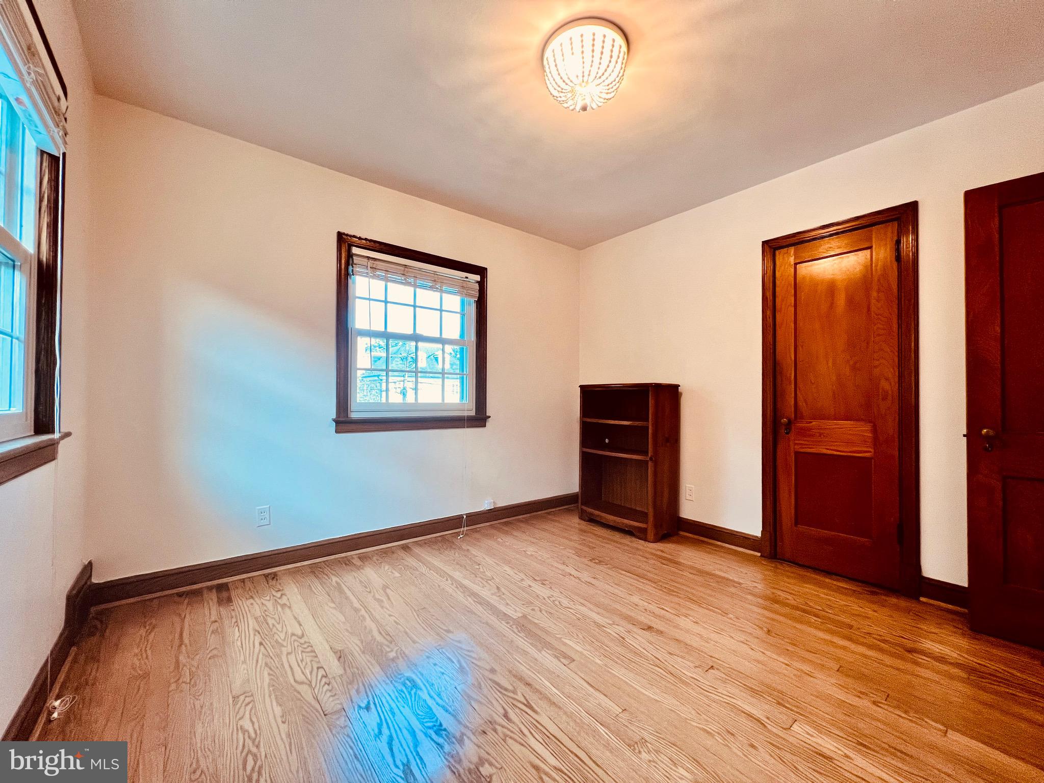 7208 Exeter Road Bethesda, MD 20814 - Photo 15 of 26 an empty room with wooden floor and windows