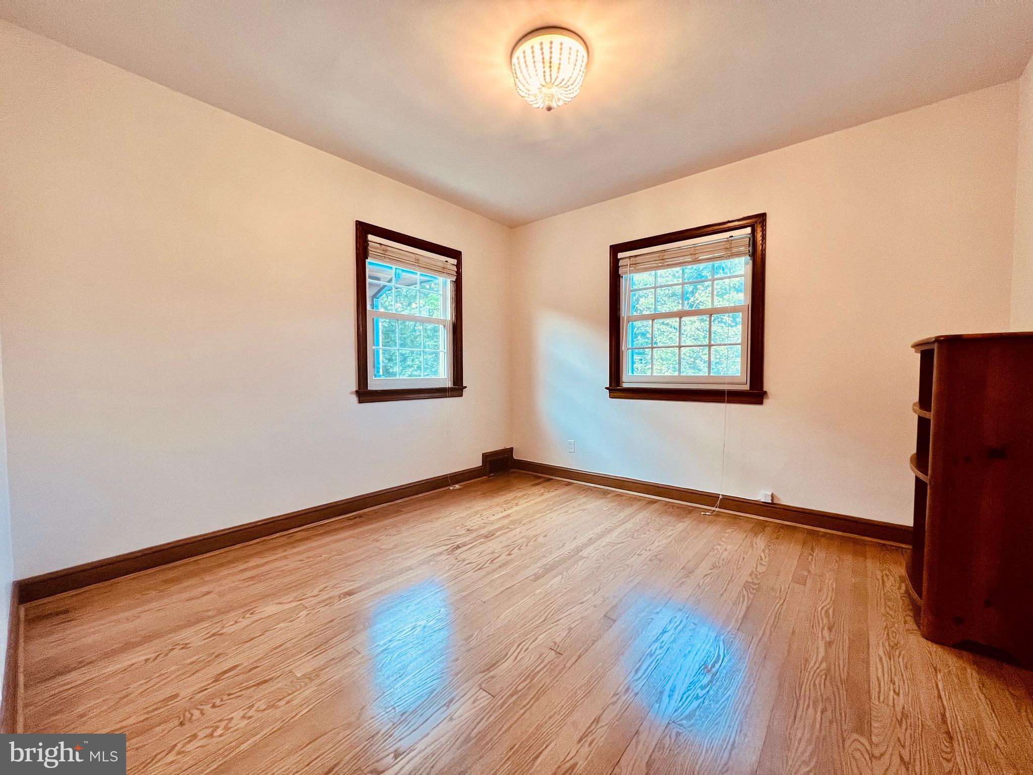 7208 Exeter Road Bethesda, MD 20814 - Photo 16 of 26 a view of an empty room with wooden floor and a window