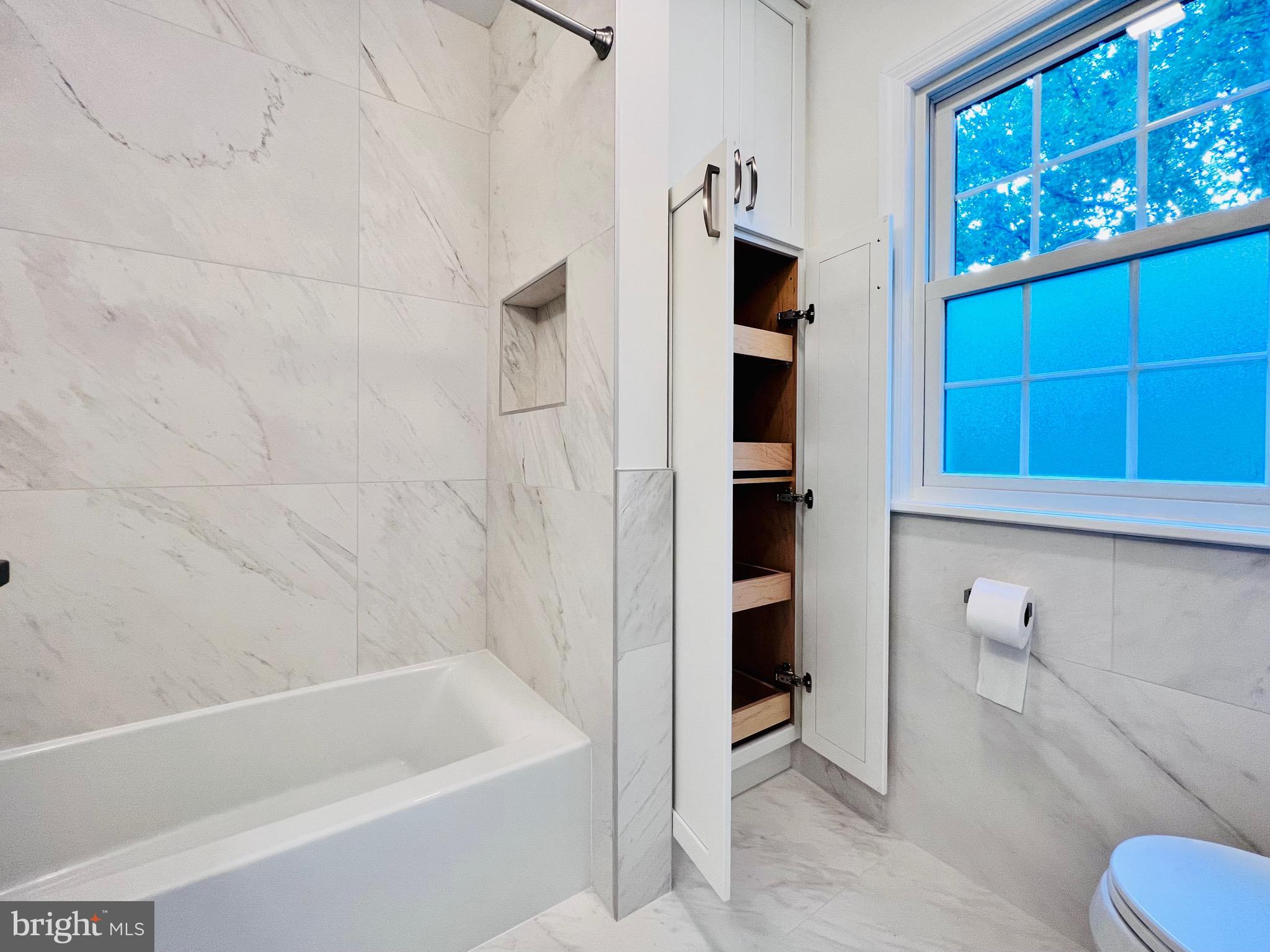 7208 Exeter Road Bethesda, MD 20814 - Photo 18 of 26 a bathroom with a bathtub and a shower