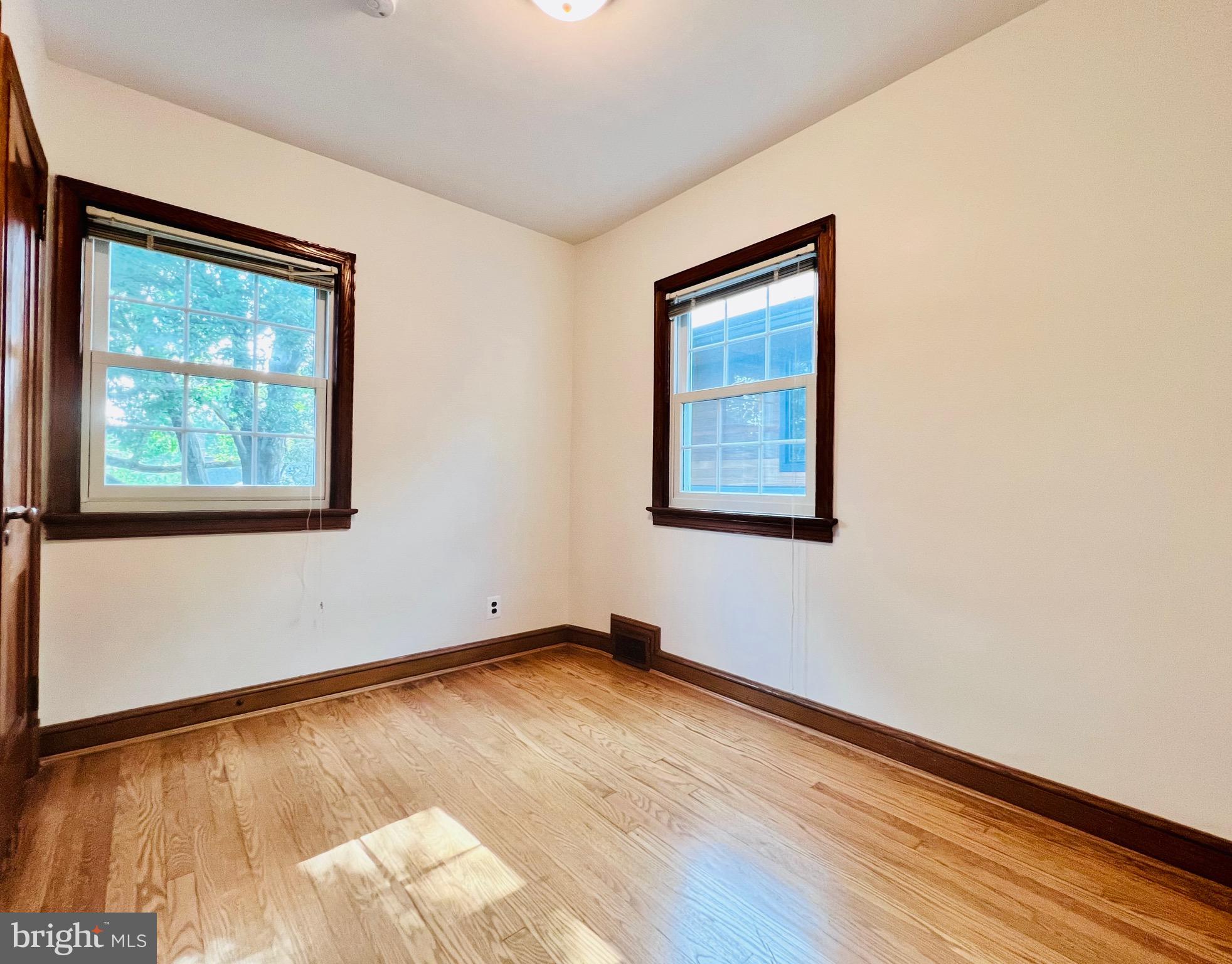 7208 Exeter Road Bethesda, MD 20814 - Photo 20 of 26 a view of an empty room with wooden floor and a window
