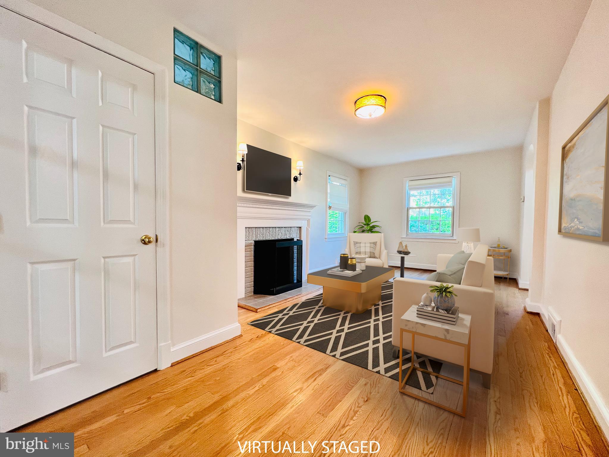 7208 Exeter Road Bethesda, MD 20814 - Photo 2 of 26 a living room with furniture a fireplace and a table