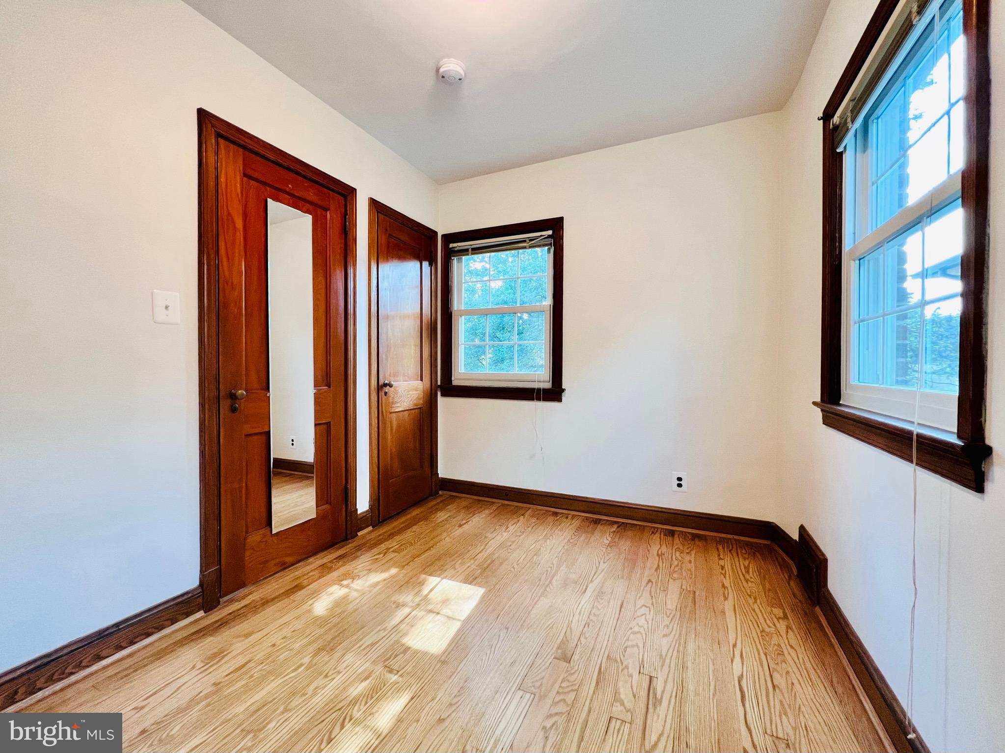 7208 Exeter Road Bethesda, MD 20814 - Photo 21 of 26 an empty room with wooden floor and windows