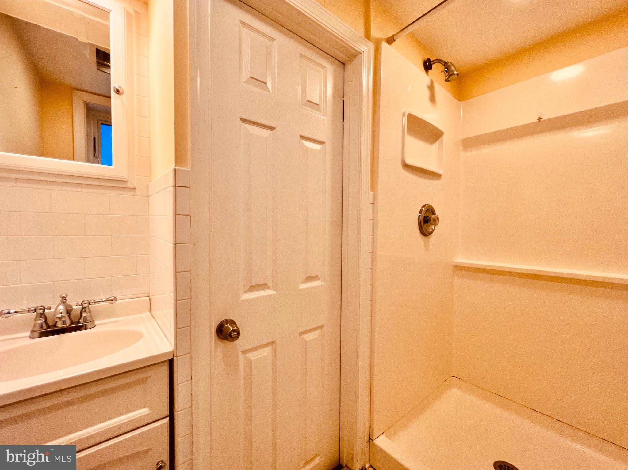 7208 Exeter Road Bethesda, MD 20814 - Photo 22 of 26 a bathroom with a shower and a sink