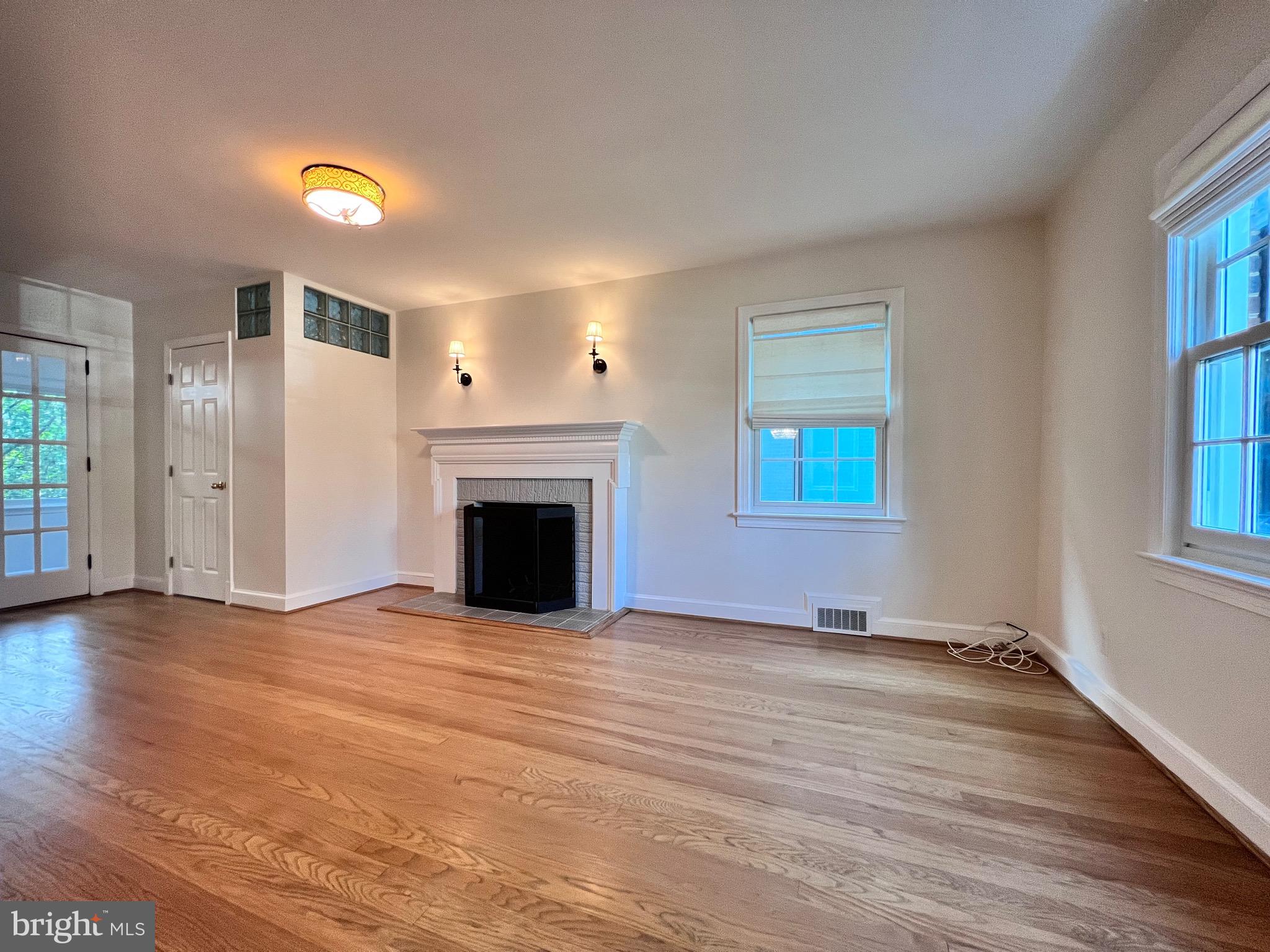 7208 Exeter Road Bethesda, MD 20814 - Photo 3 of 26 an empty room with windows and fireplace