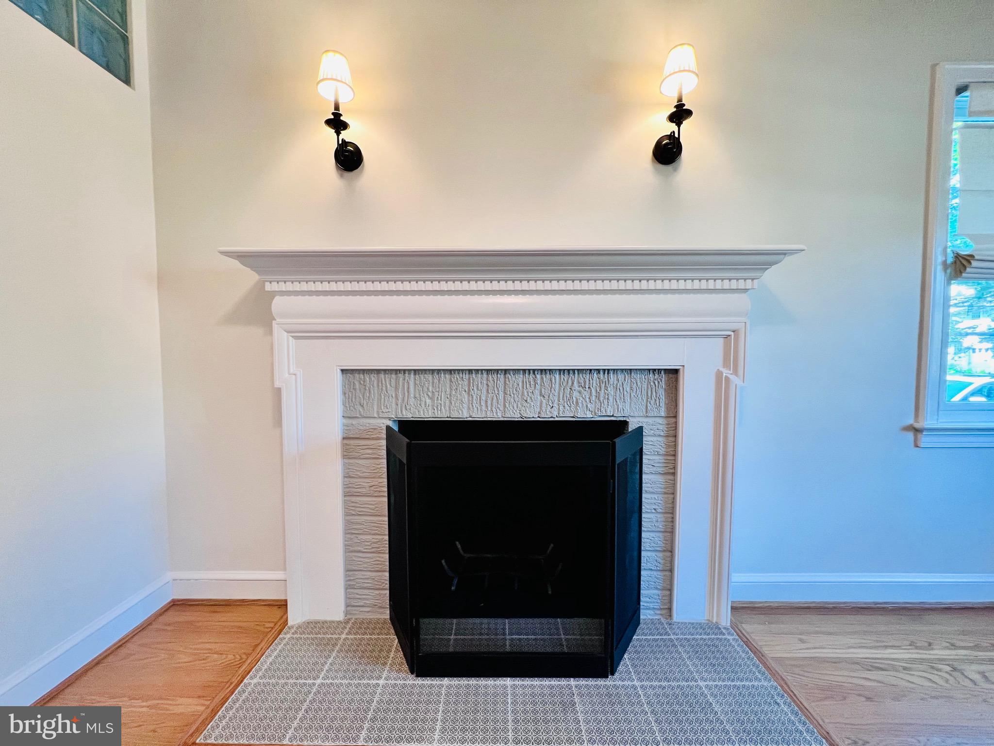 7208 Exeter Road Bethesda, MD 20814 - Photo 4 of 26 a living room with a fireplace and a table