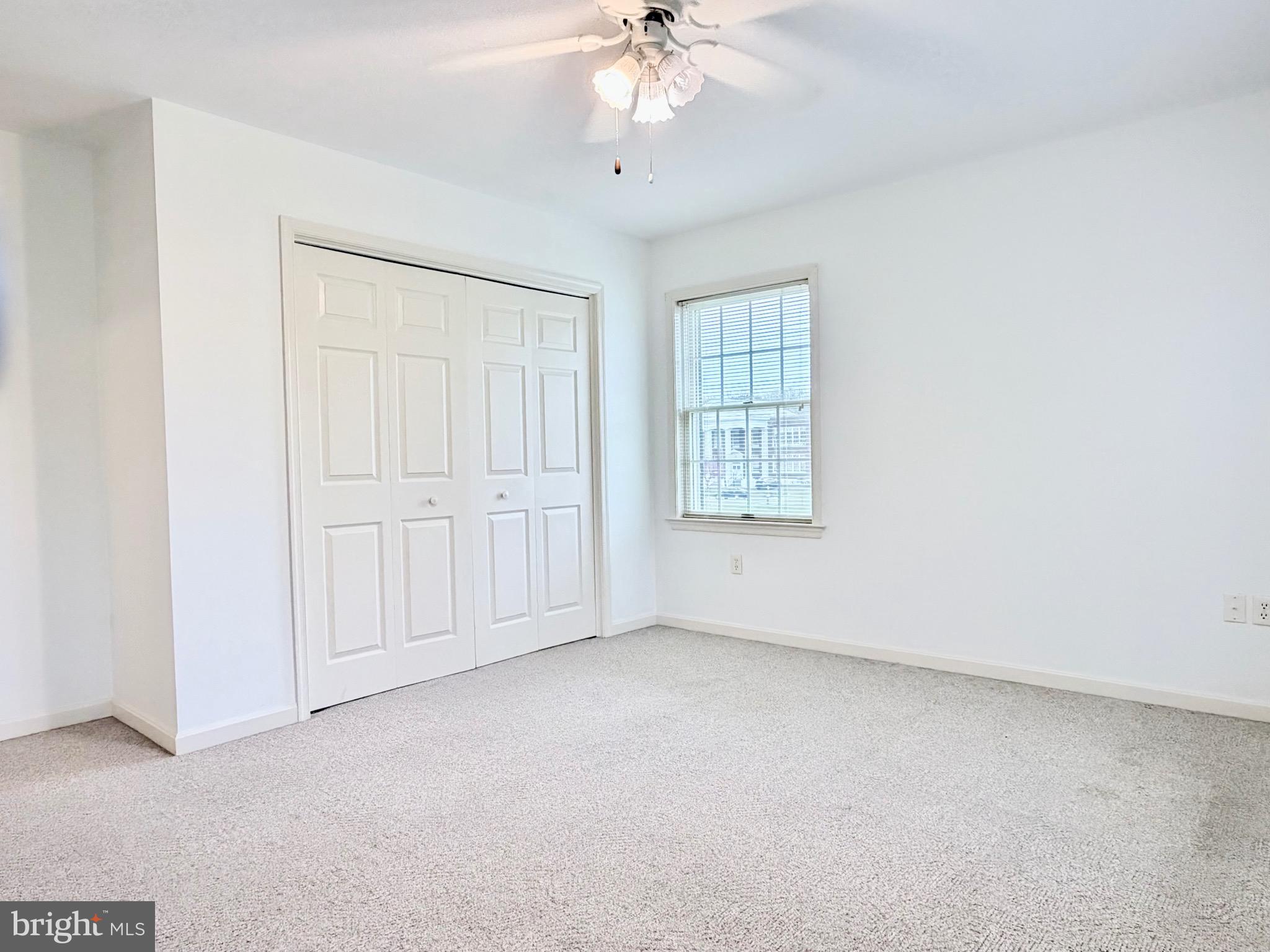 78 Brook Creek Road Toms Brook, VA 22660 - Photo 26 of 43 an empty room with chandelier fan and windows