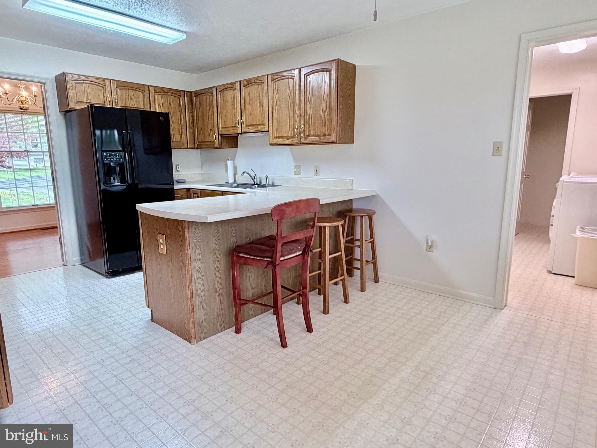 78 Brook Creek Road Toms Brook, VA 22660 - Photo 8 of 43 a kitchen with stainless steel appliances kitchen island granite countertop a refrigerator a stove top oven a sink and dishwasher