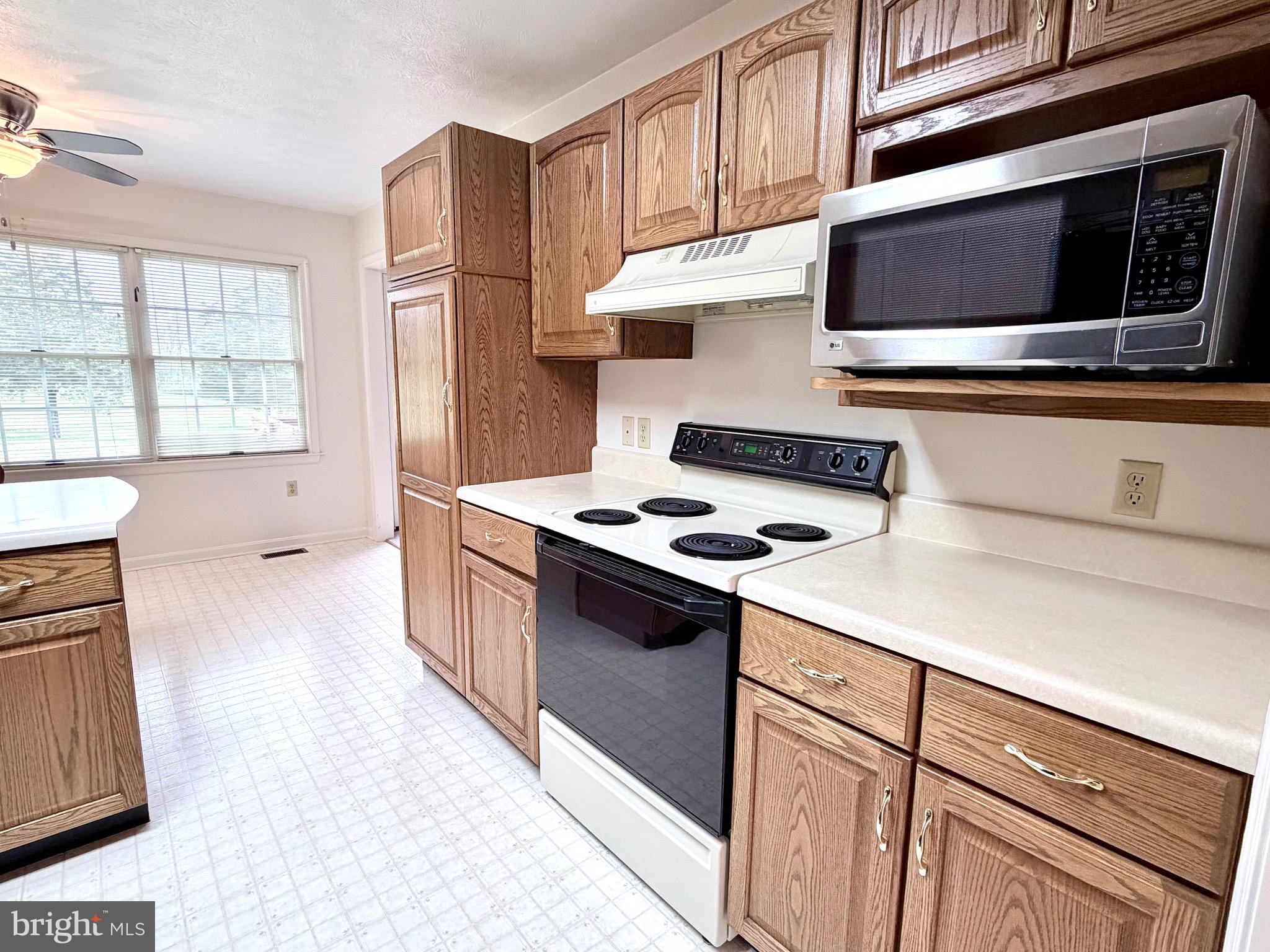 78 Brook Creek Road Toms Brook, VA 22660 - Photo 10 of 43 a kitchen with stainless steel appliances a stove microwave and cabinets