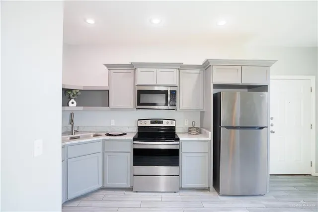 a kitchen with a refrigerator stove and microwave