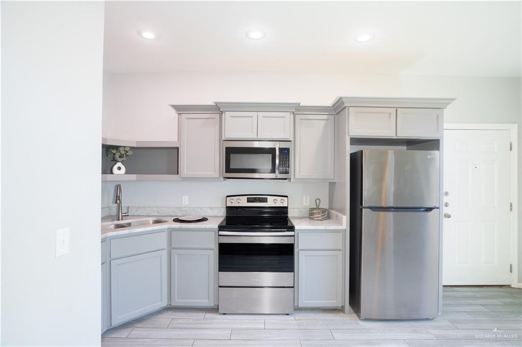 521 North Cynthia Street, Unit 2 McAllen, TX 78501 - Photo 2 of 21 a kitchen with a refrigerator stove and microwave