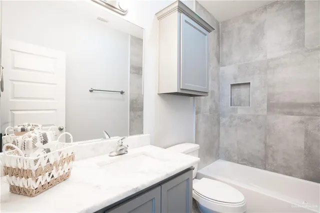 a bathroom with a sink a toilet and bathtub