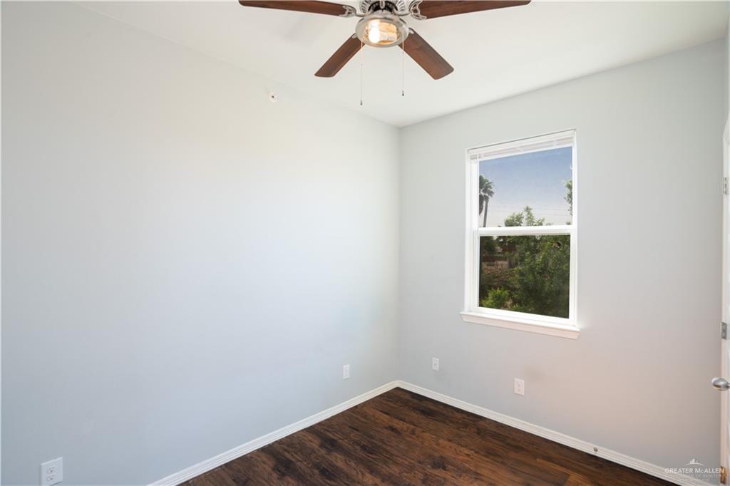 521 North Cynthia Street, Unit 2 McAllen, TX 78501 - Photo 9 of 21 a view of a small space with wooden floor and a ceiling fan