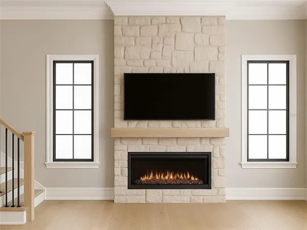 a living room with a fireplace and a flat screen tv