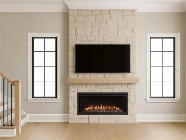 a living room with a fireplace and a flat screen tv