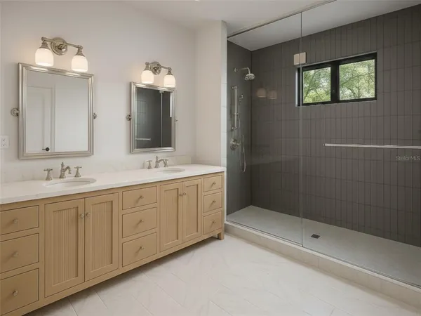 a bathroom with double sink and a mirror