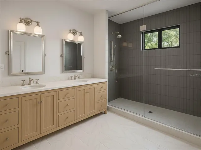 a bathroom with double sink and a mirror