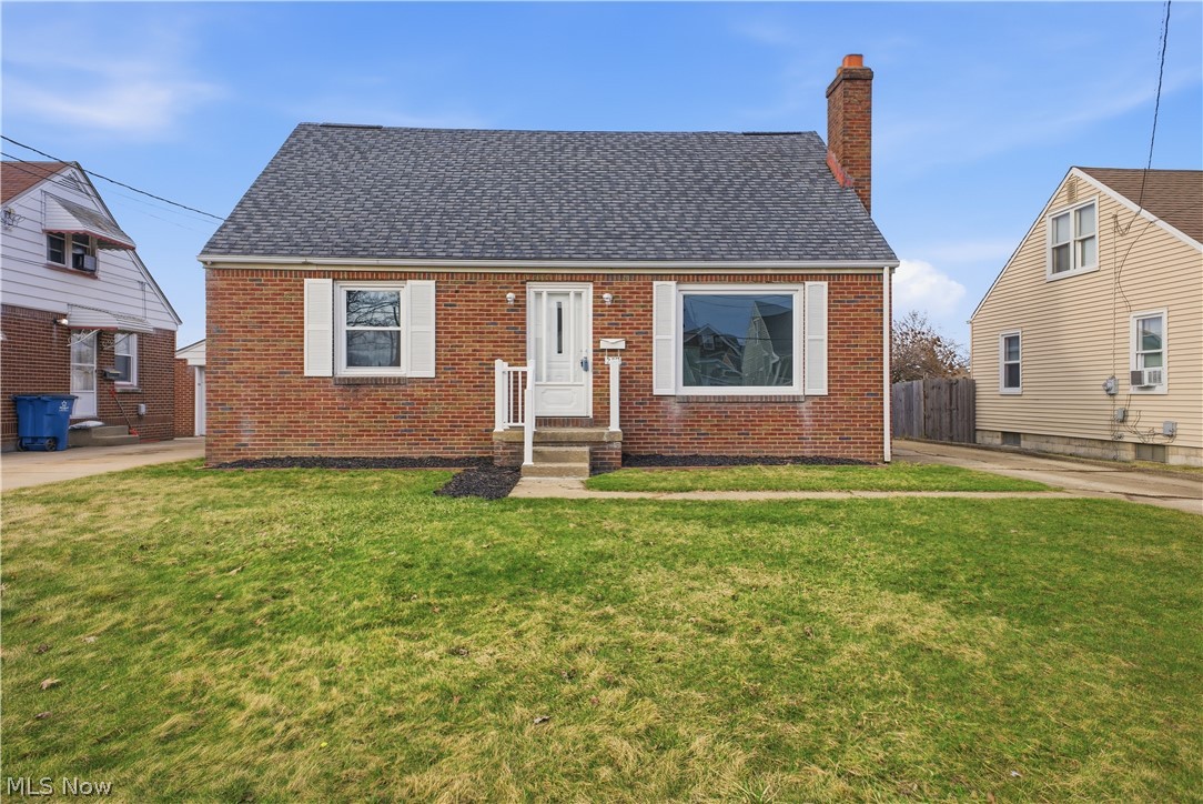 227 Wilson Street Struthers, OH 44471 - Photo 42 of 44 View of front of house with brick siding, a chimney, a shingled roof, and entry steps